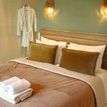 Matcha suite premium queen-size bed at Numa House, natural tones, refined ambiance