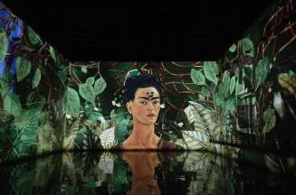 Exhibition of Frida Kahlo's paintings, reflecting in the water, at the immersive digital art center